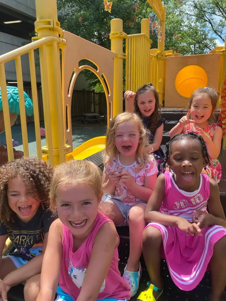 Children laughing on a playground slide.